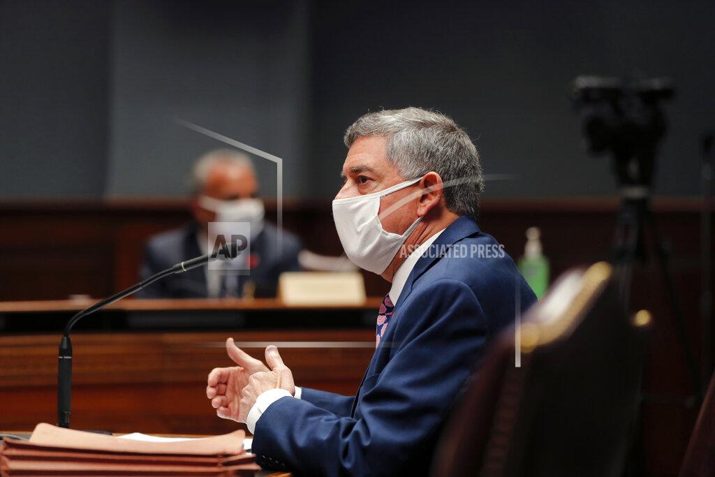 State commissioner of administration Jay Dardenne wears a mask as he testifies before the Louisiana House Appropriations Committee, in Baton Rouge, La., Monday, May 4, 2020. (AP Photo/Gerald Herbert)
