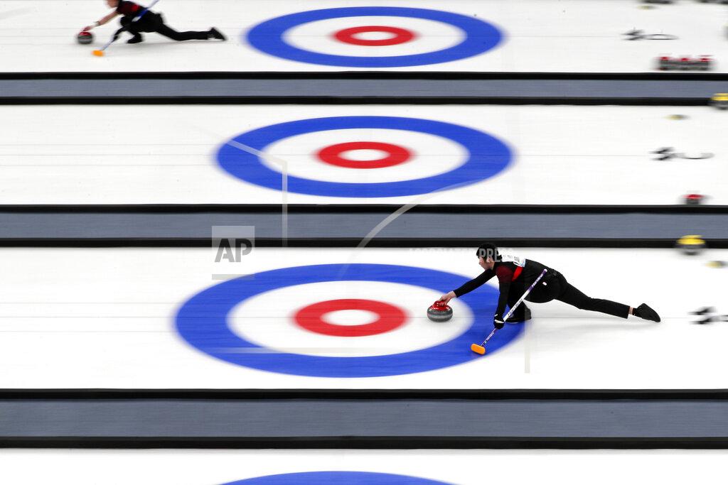 Andy Wong Local team players compete in a curling competition during a test event for the 2022 Beijing Winter Olympics at National Aquatic Center, also known as the "Water Cube" in Beijing, Thursday, April 1, 2021. Chinese capital hold a 10 days test events for 2022 Beijing Winter Olympics in five different venues from April 1-10, becomes the first city to hold both the Winter and Summer Olympics. (AP Photo/Andy Wong)