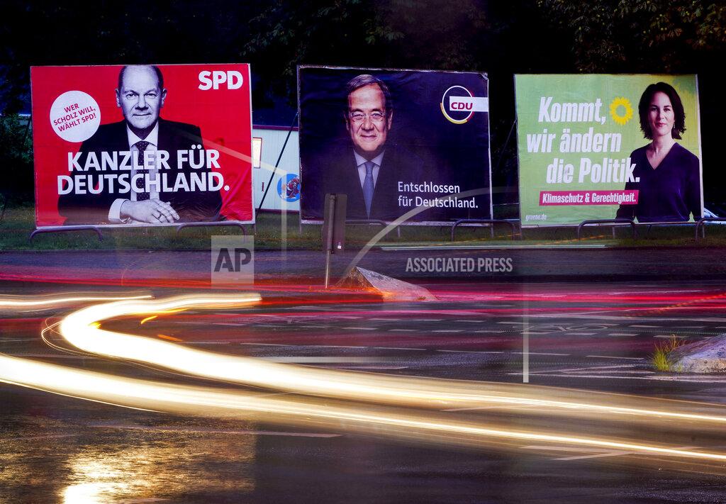 Michael Probst Three elections posters show Social Democratic top candidate for chancellor Olaf Scholz, left, Christian Democratic top candidate Armin Laschet, center, and top candidate of the Greens Annalena Baerbock in Frankfurt, Germany, Wednesday, Sept. 15, 2021. Letters read "Chancellor for Germany" for Scholz, "determined for Germany" for Scholz and "come we change politics" for Baerbock. Germany prepares for the Sept. 26 election that will determine who succeeds Chancellor Angela Merkel at the helm of Europe’s biggest economy. While some of the issues that voters say are most important to them, including climate change and the economy, are global or national in scope, the splintered election campaign has meant many are judging Germany's next leader by focusing on intensely local and personal questions. (AP Photo/Michael Probst)
