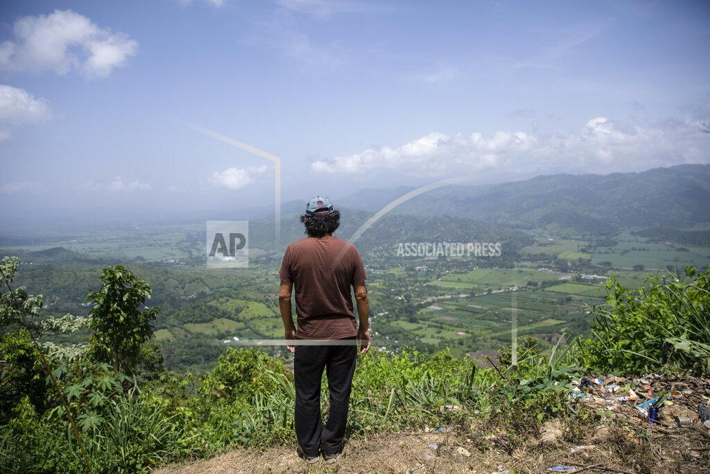Rodrigo Abd Friar Leopoldo Serrano surveys the landscape where he built a rehab center for drug addicts, in Mission San Francisco de Asis, Honduras, Tuesday, July 15, 2021. As Serrano stood on the lookout over the valley, he said, “Half of all the land and businesses you see from here belong to drug traffickers." (AP Photo/Rodrigo Abd)