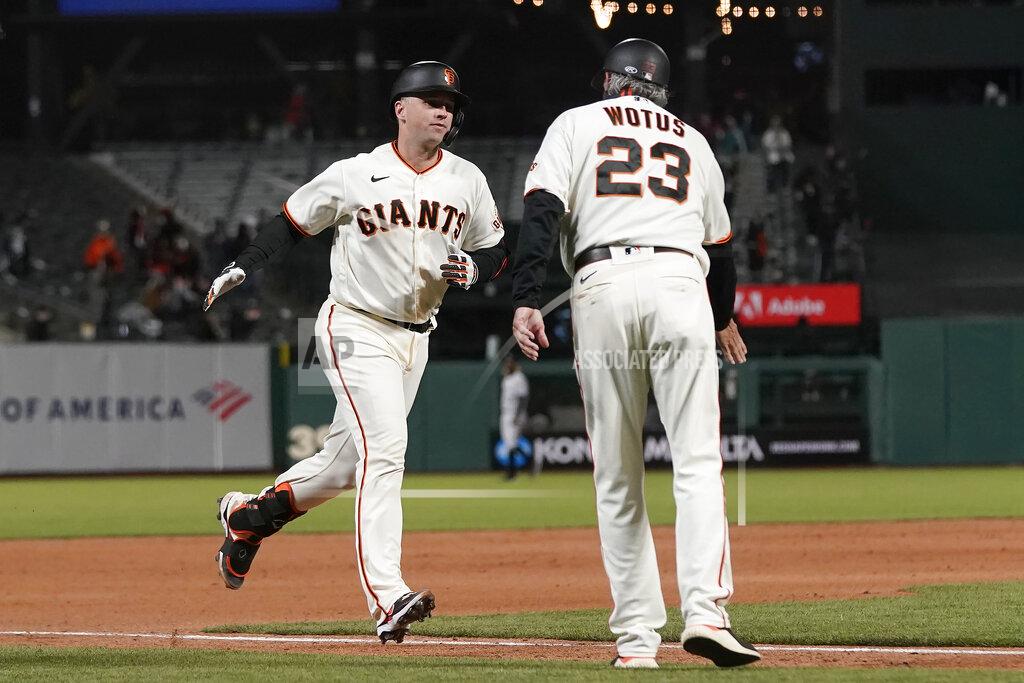 Jeff Chiu San Francisco Giants' Buster Posey, left, is congratulated by third base coach Ron Wotus (23) after hitting a two-run home run against the Colorado Rockies during the sixth inning of a baseball game in San Francisco, Monday, April 26, 2021. (AP Photo/Jeff Chiu)