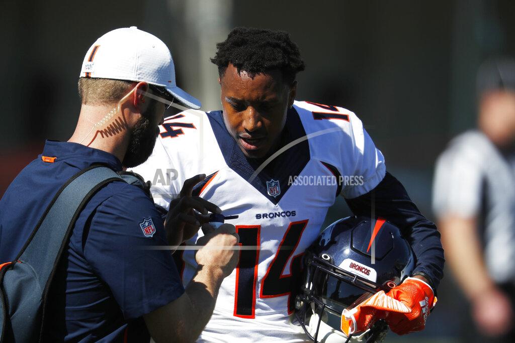 Denver Broncos wide receiver Courtland Sutton (14) gets sunscreen from a field assistant during drills at the team's NFL football training camp Friday, July 19, 2019, in Englewood, Colo. (AP Photo/David Zalubowski)