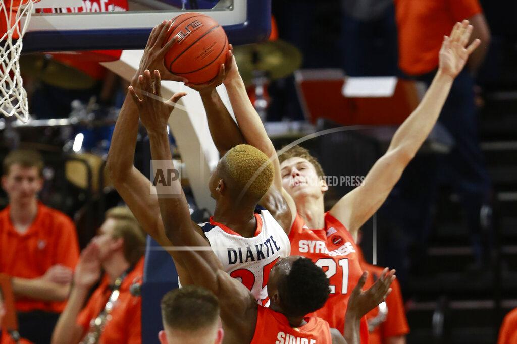 Steve Helber Syracuse forward Bourama Sidibe, bottom,, and forward Marek Dolezaj (21) try to block the shot of Virginia forward Mamadi Diakite (25) during the first half of an NCAA college basketball game in Charlottesville, Va., Saturday, Jan. 11, 2020. (AP Photo/Steve Helber)