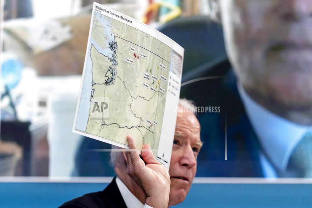 Andrew Harnik President Joe Biden holds up a map of wildfires in Washington state as he speaks with governors about ongoing efforts to strengthen wildfire prevention, preparedness and response efforts, and hear firsthand about the ongoing impacts of the 2021 wildfire season in the South Court Auditorium in the Eisenhower Executive Office Building on the White House Campus in Washington, Friday, July 30, 2021. (AP Photo/Andrew Harnik)