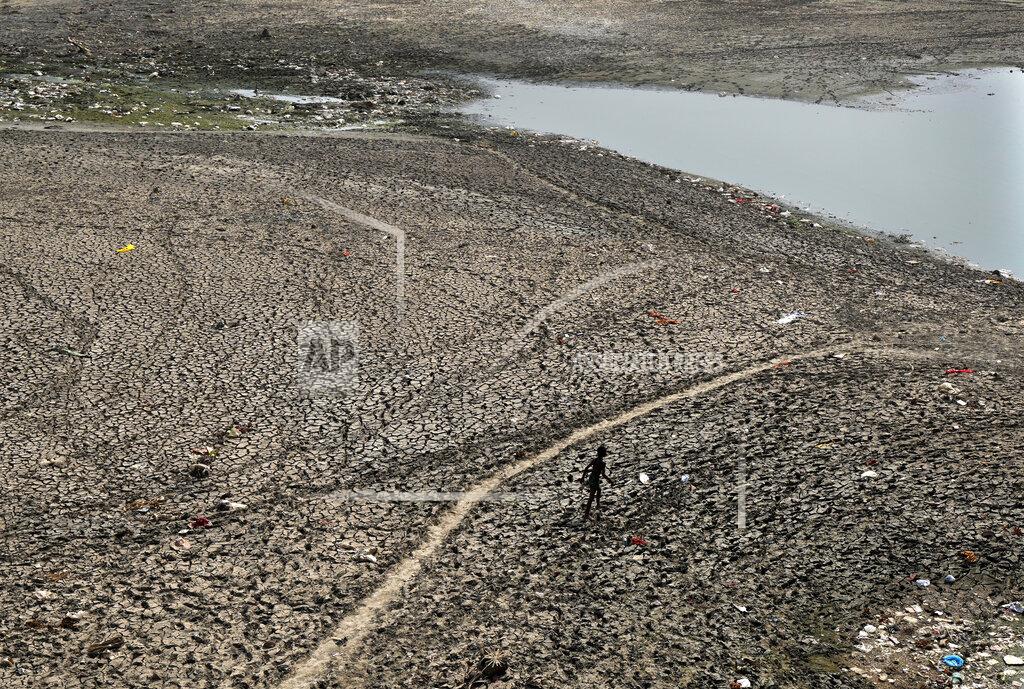 Manish Swarup A man walks across a dried patch of the river Yamuna as water level reduces drastically following heat wave to in New Delhi, Monday, May 2, 2022. The intense heat wave sweeping through South Asia was made more likely due to climate change and it is a sign of things to come. An analysis by international scientists said that this heat wave was made 30-times more likely because of climate change, and future warming would make heat waves more common and hotter in the future. (AP Photo/Manish Swarup)