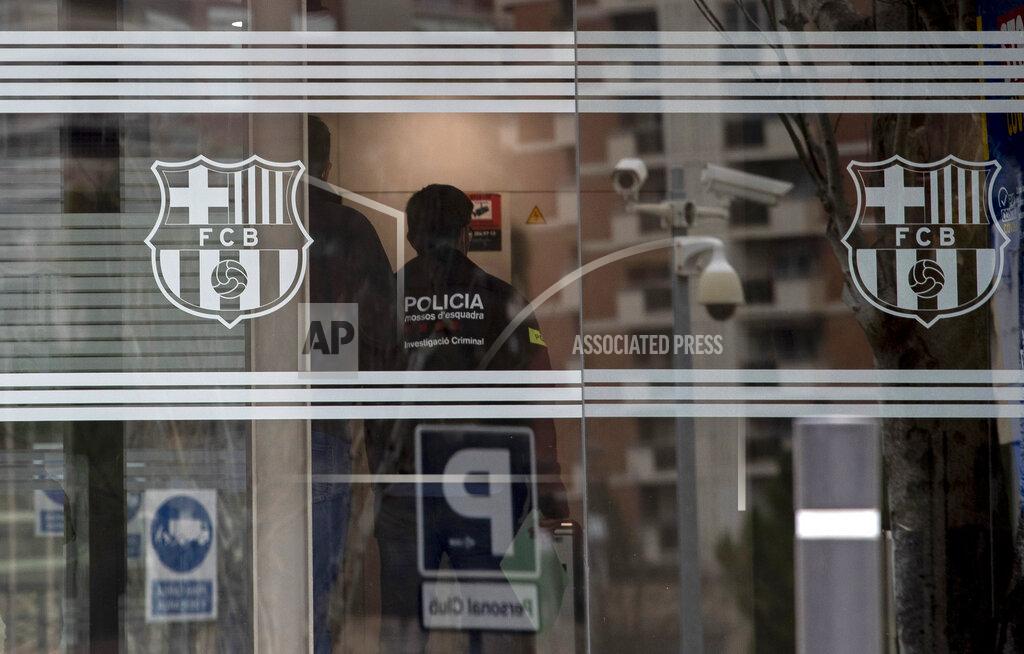 Joan Monfort FILE - In this file photo dated Monday March 1, 2021, Catalan police enter FC Barcelona's offices in Barcelona, Spain, where they detained several people in a search and seize operation. Over 110,000 Barcelona club members will elect a new president Sunday March 7, 2021, amidst a club crisis with police investigation and a debt burden. (AP Photo/Joan Monfort, FILE)