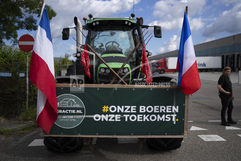 Peter Dejong A sign reads "Our Farmers, Our Future" as some 25 tractors put up a blockade outside a distribution center for supermarket chain Albert Heijn in the town of Zaandam, just north of Amsterdam, Monday, July 4, 2022. Dutch farmers angry at government plans to slash emissions used tractors and trucks Monday to blockade supermarket distribution centers, the latest actions in a summer of discontent in the country's lucrative agricultural sector. (AP Photo/Peter Dejong)