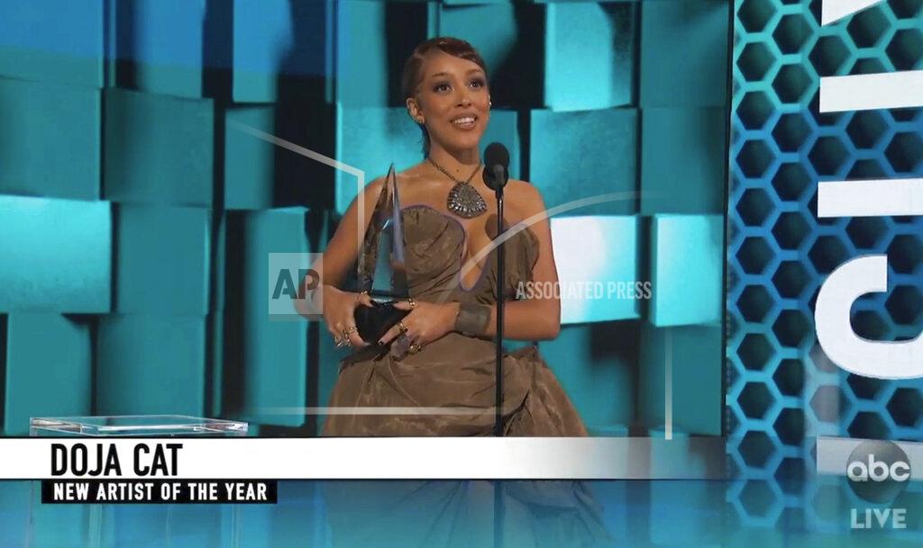 Uncredited In this screen shot provided by ABC on Sunday, Nov. 22, 2020, Doja Cat accepts the award for new artist of the year at the American Music Awards at the Microsoft Theater in Los Angeles. (ABC via AP)