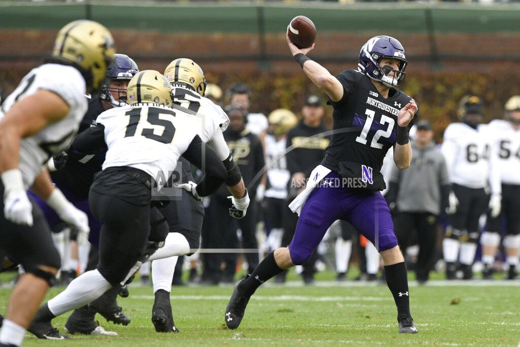 Paul Beaty Northwestern quarterback Ryan Hilinski (12) throws during the first half of a NCAA football game against Purdue, Nov. 20, 2021 at Wrigley Field in Chicago. Purdue won 32-14. (AP Photo/Paul Beaty)