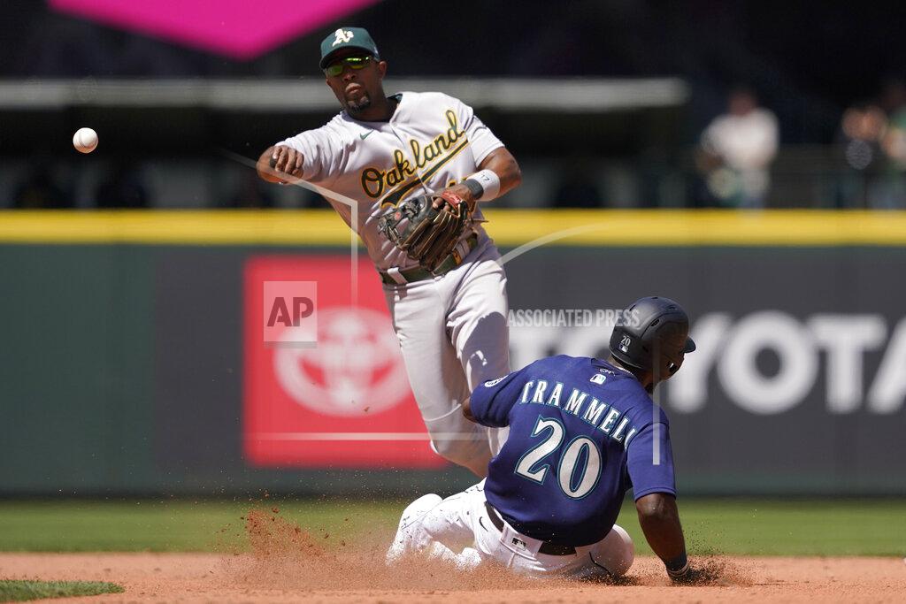 Ted S. Warren Seattle Mariners' Taylor Trammell (20) is forced out at second as Oakland Athletics' shortstop Elvis Andrus makes the throw to first to get Luis Torrens out for the double play during the fifth inning of a baseball game, Wednesday, May 25, 2022, in Seattle. (AP Photo/Ted S. Warren)