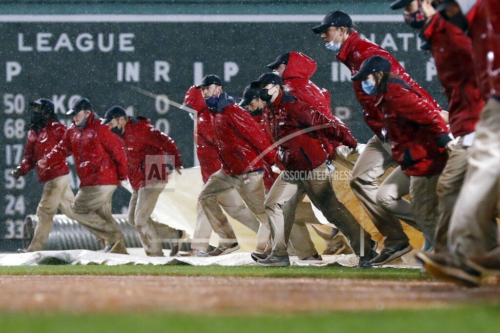 Michael Dwyer The Fenway Park grounds crew pulls out the tarp during a rain delay during a baseball game between the Boston Red Sox and the Miami Marlins during the sixth inning Friday, May 28, 2021, in Boston. (AP Photo/Michael Dwyer)