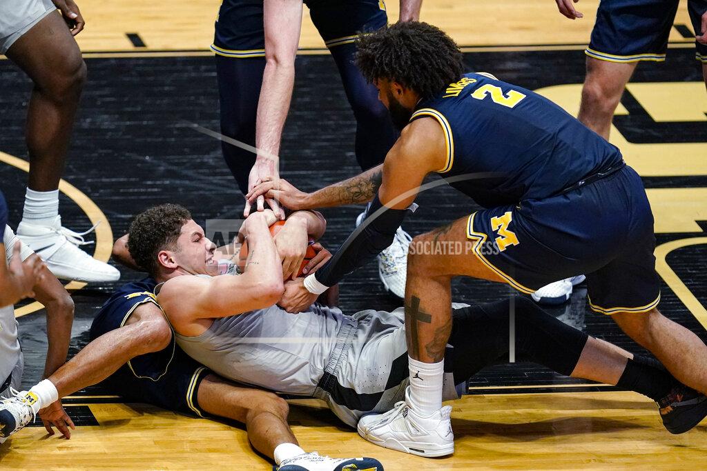 Michael Conroy Purdue forward Mason Gillis (0) and Michigan forward Isaiah Livers (2) try to get possession of the ball during the second half of an NCAA college basketball game in West Lafayette, Ind., Friday, Jan. 22, 2021. (AP Photo/Michael Conroy)