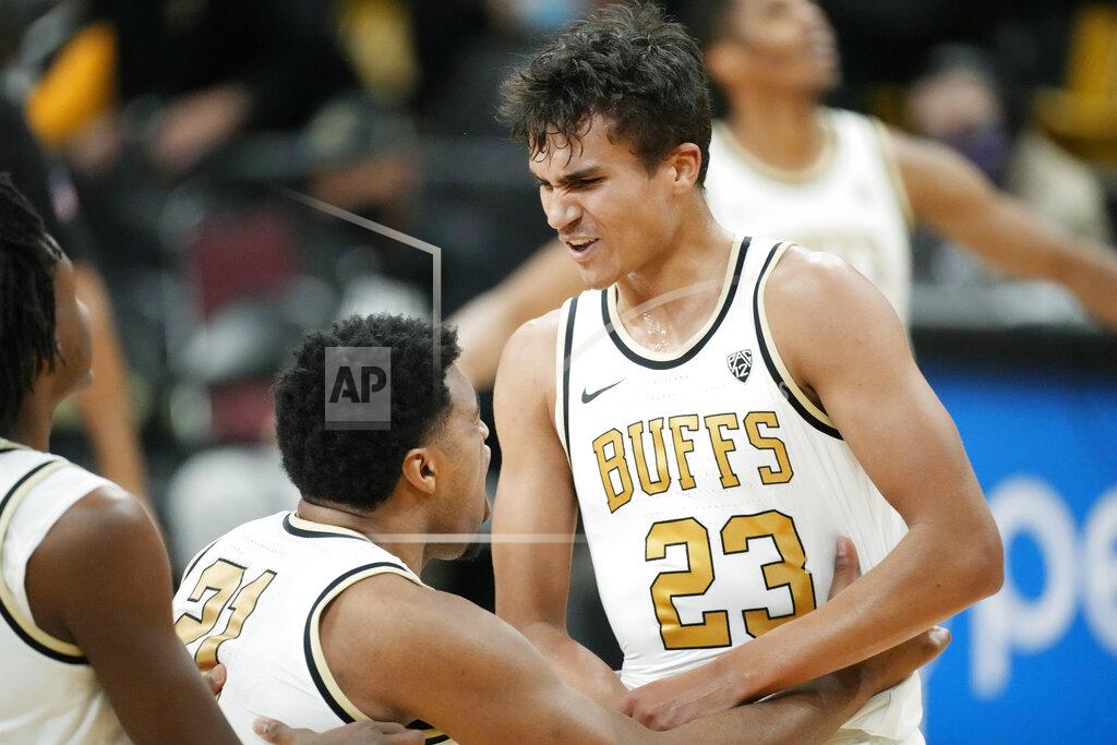 David Zalubowski Colorado forward Evan Battey, left, celebrates with forward Tristan da Silva after he hit a basket against Washington in the first first half of an NCAA college basketball game Sunday, Jan. 9, 2022, in Boulder, Colo. (AP Photo/David Zalubowski)