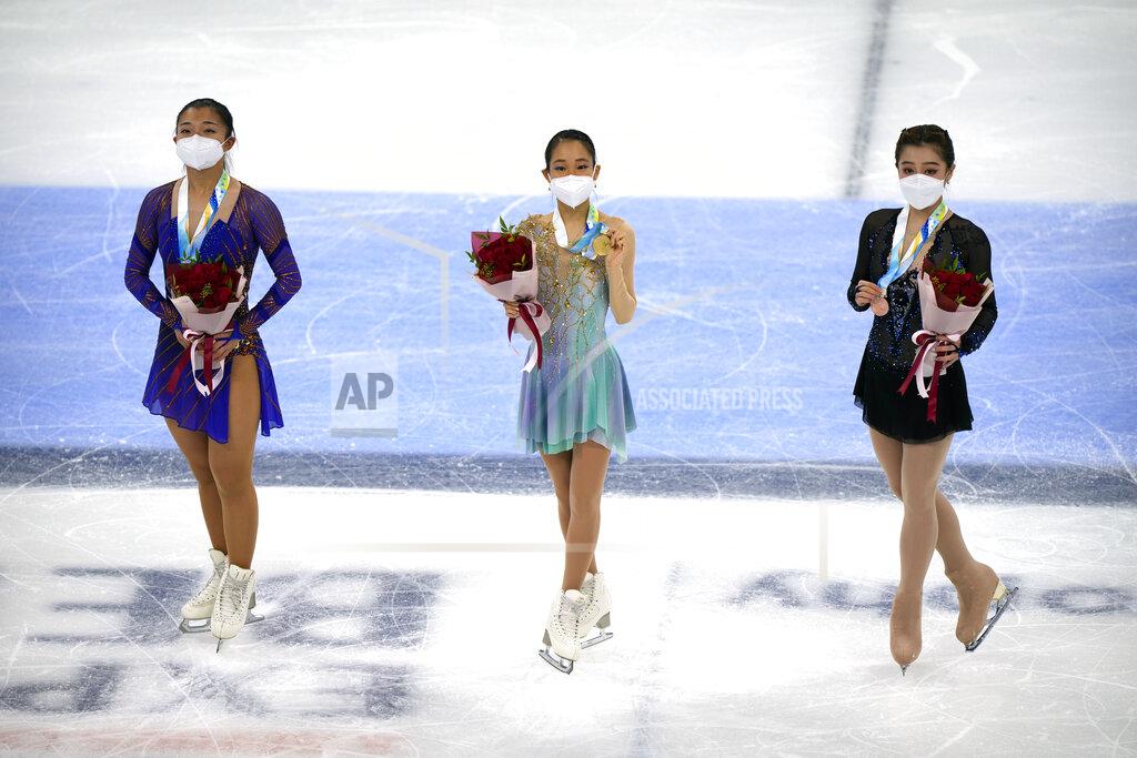 Mark Schiefelbein From left, women's singles silver medalist Kaori Sakamoto of Japan, gold medalist Mai Mihara of Japan, and bronze medalist Joanna So of Hong Kong pose on the ice during their medal ceremony at the Asian Open Figure Skating Trophy, a test event for the 2022 Winter Olympics, at the Capital Indoor Stadium in Beijing, Friday, Oct. 15, 2021. (AP Photo/Mark Schiefelbein)