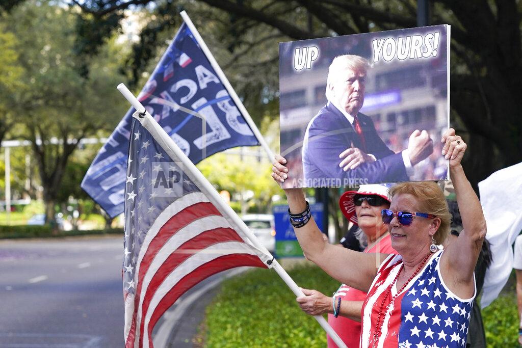 John Raoux Trump supporters wave flags and signs to motorists driving by the convention center at the Conservative Political Action Conference (CPAC) Saturday, Feb. 27, 2021, in Orlando, Fla. (AP Photo/John Raoux)