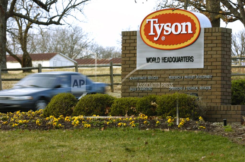 FILE - In this Jan. 29, 2006, file photo, a car passes in front of a Tyson Foods Inc., sign at Tyson headquarters in Springdale, Ark. Tyson Foods plans to administer thousands of coronavirus tests per week at its U.S. facilities under an expanded effort to protect workers and keep plants running. The Springdale, Arkansas-based company, which processes about 20% of all beef, pork and chicken in the U.S., on Wednesday, July 29, 2020, said it will randomly test employees who have no symptoms as well as those with symptoms (AP Photo/April L. Brown, File)