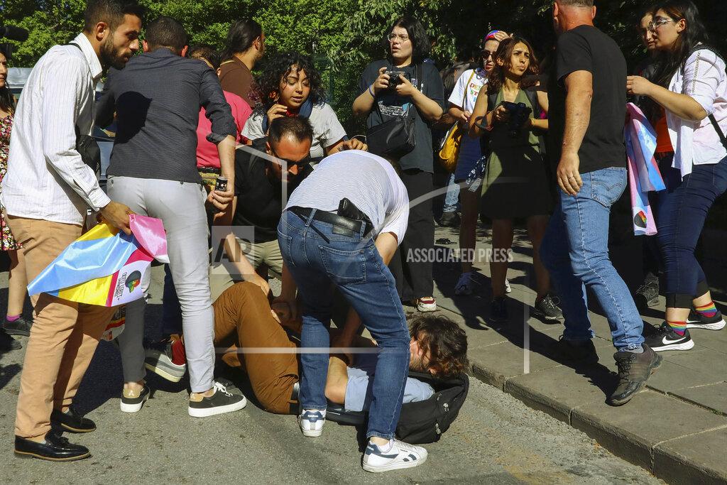 Ali Unal Protesters clash with Turkish police officers during the LGBTQ Pride March in Ankara, Turkey, Tuesday, July 5, 2022. Police broke up a LGBTQ Pride march in the Turkish capital Ankara on Tuesday and detained dozens of people. (AP Photo/Ali Unal)