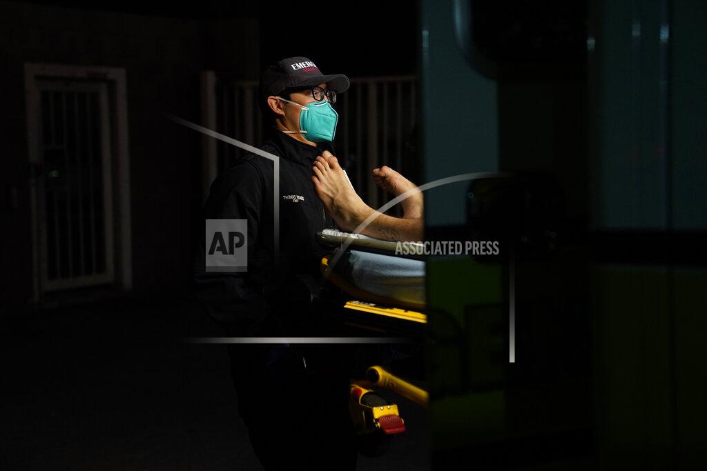 Jae C. Hong Emergency medical technician Thomas Hoang, 29, of Emergency Ambulance Service, loads a patient into an ambulance in Placentia, Calif., Friday, Jan. 8, 2021. EMTs and paramedics have always dealt with life and death — they make split-second decisions about patient care, which hospital to race to, the best and fastest way to save someone — and now they're just a breath away from becoming the patient themselves. (AP Photo/Jae C. Hong)