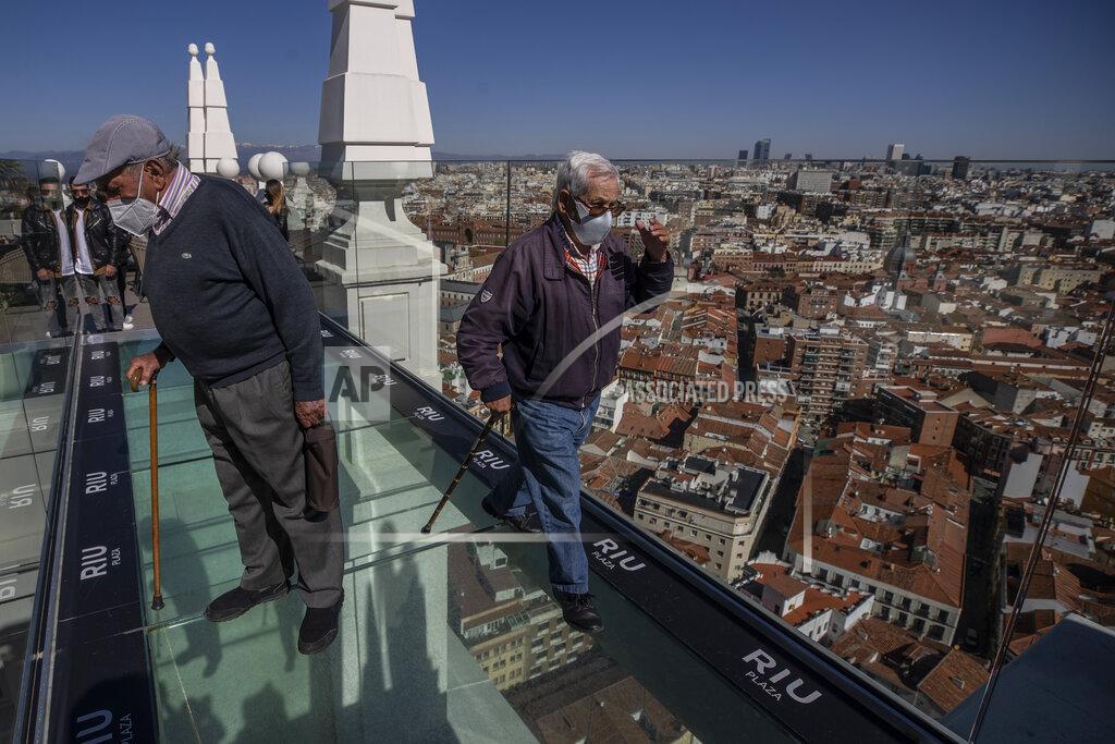 Residents of different nursing homes take their first excursion outside their care homes after been vaccinated with the skyline of Madrid in the background in Madrid, Spain, Monday, March 15, 2021. The group are now protected from the deadly COVID-19 virus having received their vaccination a few weeks ago. The care home managers thought that it was time for them to enjoy a trip into central Madrid to take in the sights and stretch their legs. (AP Photo/Manu Fernandez)