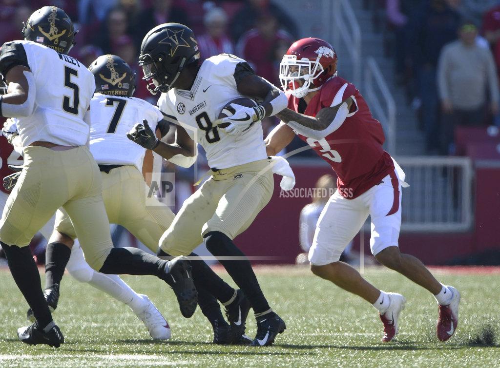 Michael Woods Vanderbilt defender Joejuan Williams is tackled by Arkansas receiver Koilan Jackson after an interception in the first half of an NCAA college football game Saturday, Oct. 27, 2018, in Fayetteville, Ark. (AP Photo/Michael Woods)