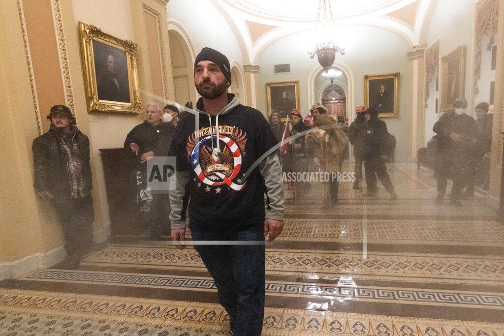 Manuel Balce Ceneta Smoke fills the walkway outside the Senate Chamber as supporters of President Donald Trump are confronted by U.S. Capitol Police officers inside the Capitol, Wednesday, Jan. 6, 2021 in Washington. (AP Photo/Manuel Balce Ceneta)