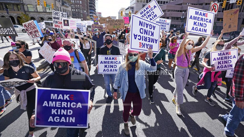 Rick Bowmer People walk to the Utah State Capitol during the Women's March Saturday, Oct. 17, 2020, in Salt Lake City. Dozens of Women's March rallies were planned from New York to San Francisco to signal opposition to President Donald Trump and his policies, including the push to fill the seat of late Supreme Court Justice Ruth Bader Ginsburg before Election Day. (AP Photo/Rick Bowmer)
