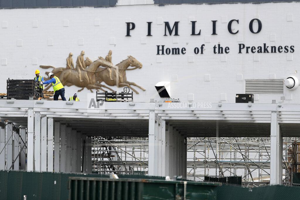 Julio Cortez A crew works on putting up a platform near the main entrance at Pimlico Race Course, Friday, May 15, 2020, in Baltimore. Horse racing is in a state of transition at a time usually reserved for Triple Crown season. The Preakness would have been run Saturday, May 16, 2020, in Baltimore. But Pimlico Race Course and many tracks across North America remain dark because of the coronavirus pandemic. (AP Photo/Julio Cortez)