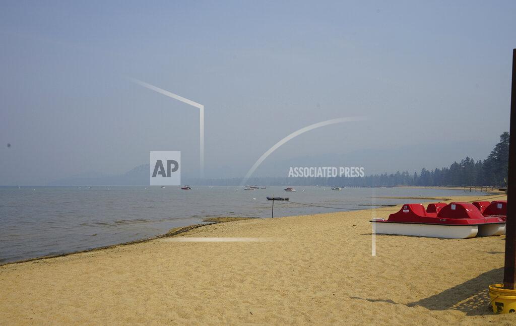 Samuel Metz FILE - In this Sept. 6, 2021, file photo, smoke shrouds parts of Lake Tahoe visible from Ski Run Marina in downtown South Lake Tahoe, Calif. With wildfire no longer threatening Lake Tahoe, residents, tourists and scientists drawn to its clean alpine air, clear blue waters and fragrant pine trees now wonder about the long-term effects that will remain after wildfire season ends. (AP Photo/Samuel Metz,File)