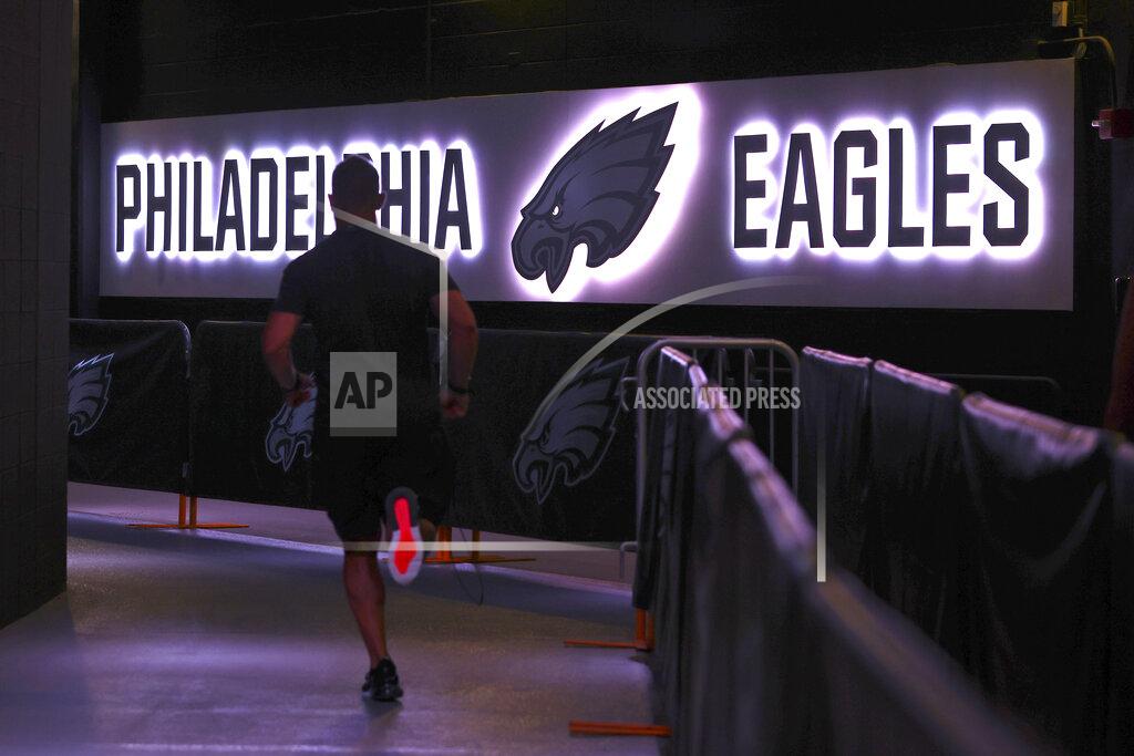 FILE - In this Thursday, Aug. 19, 2021, file photo, a Philadelphia Eagles' player runs back to the locker room before a preseason NFL football game against the New England Patriots in Philadelphia. The NFL has mandated that only fully vaccinated personnel, with a maximum of 50 people, will have access to locker rooms while players are present on game days. Players are not required to be vaccinated against COVID-19, but the NFL has reported that more than 90% of them are. (AP Photo/Rich Schultz, File)