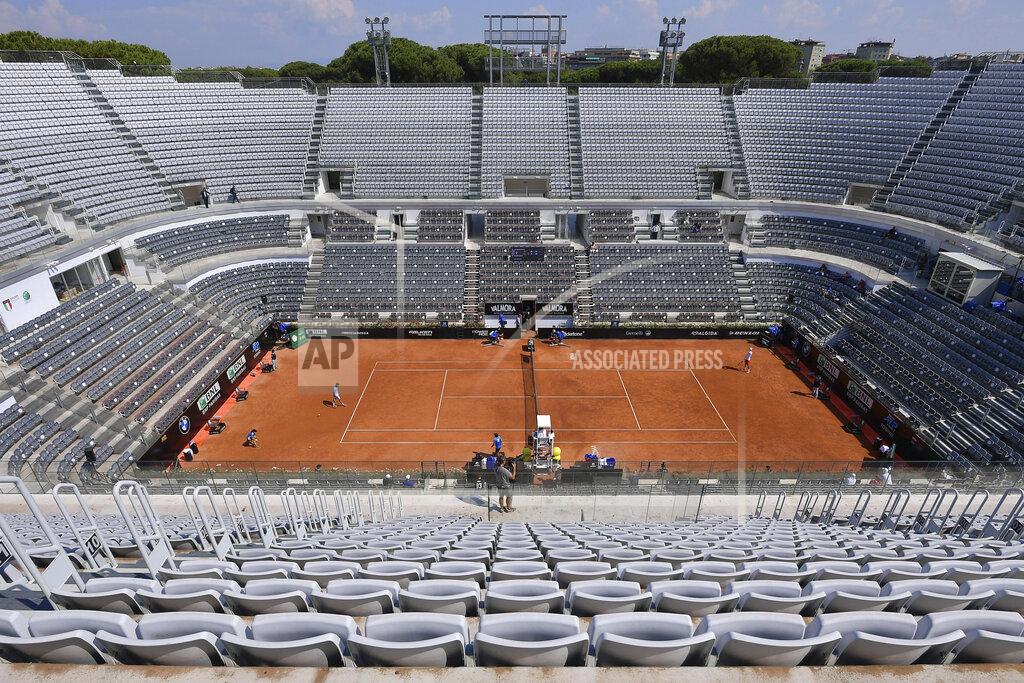 Alfredo Falcone The stands around the Central Court of the Foro Italico are empty during a match between Serbia's Novak Djokovic and Italy's Salvatore Caruso, at the Italian Open tennis tournament in Rome, Wednesday, Sept. 16, 2020. The tournament at the Foro Italico was rescheduled from May because of the pandemic and is being played without fans in attendance. (Alfredo Falcone/LaPresse via AP)
