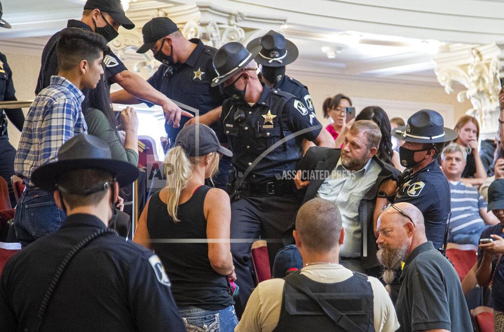 Darin Oswald FILE - In this Aug. 26, 2020, file photo, Ammon Bundy is dragged from the Idaho Senate Chambers gallery by Idaho State Troopers after returning to the Idaho Statehouse in Boise, Idaho. When President Trump-supporting insurrectionists stormed the U.S. Capitol in an attempt to overturn the presidential election on Wednesday, Jan. 6 2021 the nation was shocked, but not unwarned. A series of dress rehearsals of sorts have played out in statehouses in Michigan, Oregon, Idaho and elsewhere in recent months, with armed protesters forcing their way into buildings. (Darin Oswald/Idaho Statesman via AP)