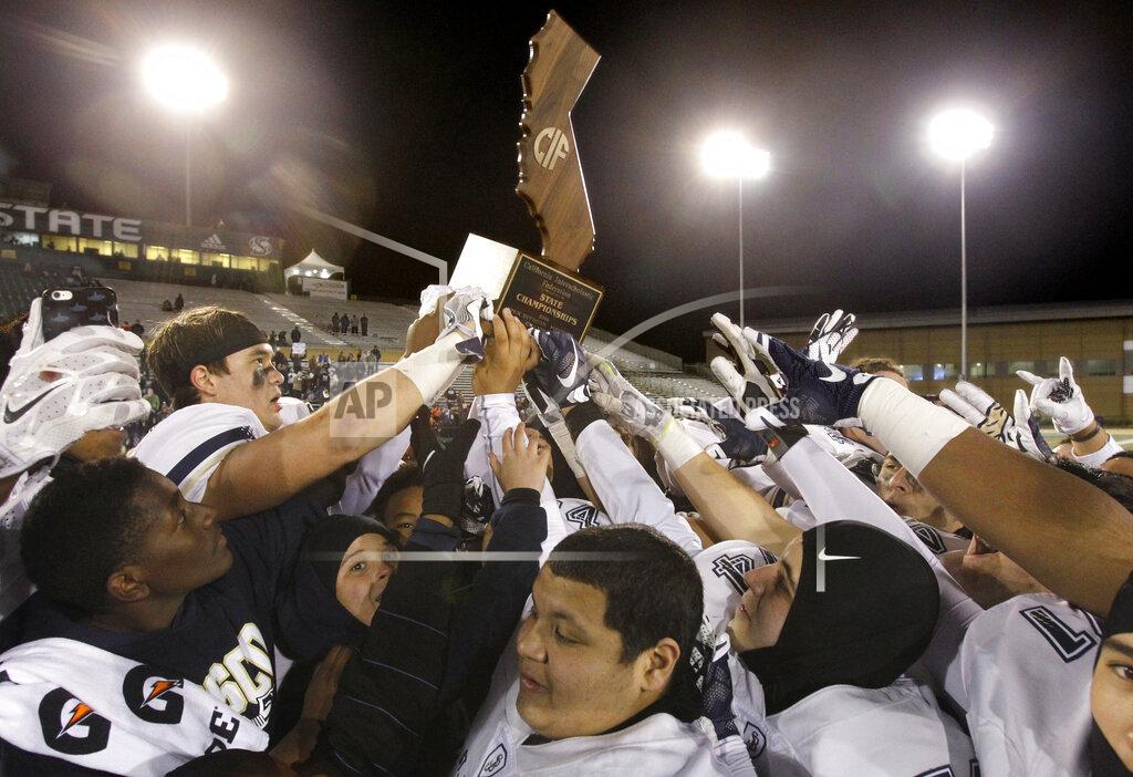 Steve Yeater FILE - In this Saturday, Dec. 17, 2016 file photo, The St. John Bosco Braves celebrate their 56-33 defeat of De La Salle to win the Open Division high school football championship game in Sacramento, Calif. The California Interscholastic Federation, California's governing body for high school sports, said Monday, July 20, 2020 that the 2020-21 sports seasons will begin no earlier than December due to the coronavirus pandemic. The CIF said the normal fall, winter and spring sports seasons will be condensed into two seasons.(AP Photo/Steve Yeater, File)