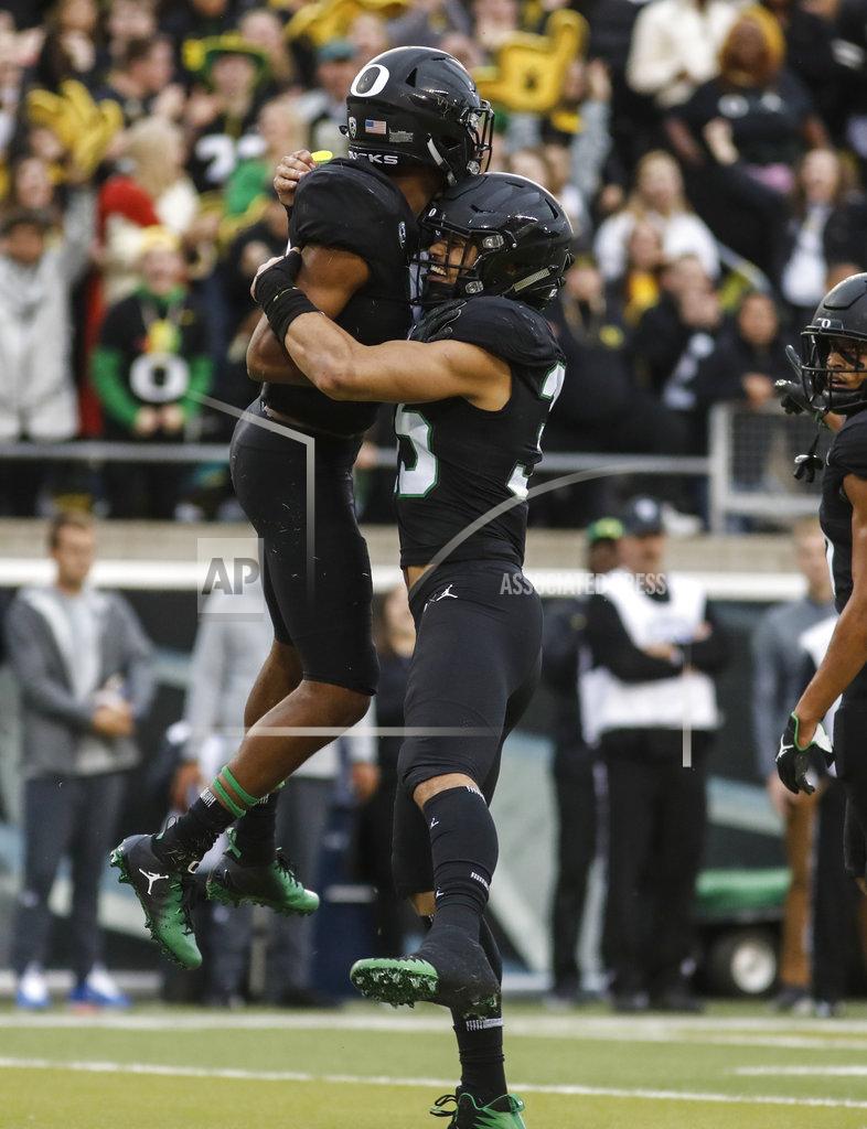 Thomas Boyd Oregon safety Jevon Holland (8), celebrates his touchdown with linebacker Troy Dye (35) during an NCAA college football game against UCLA in Eugene, Ore., Saturday, Nov. 3, 2018 (AP Photo/Thomas Boyd)