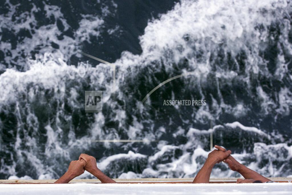 Binsar Bakkara Two passengers look out to sea from a ferry headed to Nunukan, Indonesia on Monday, Dec. 3, 2018, the last stop before crossing the border to Malaysia. Many Indonesian workers from impoverished regions of their sprawling archipelagic nation sometimes travel for days by boat to find work on palm oil plantations in Malaysia. (AP Photo/Binsar Bakkara)