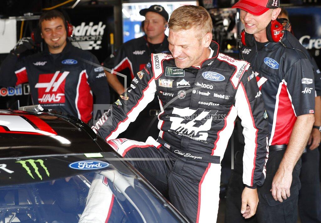 Carlos Osorio Clint Bowyer climbs into his car before practice for a NASCAR cup series auto race at Michigan International Speedway, Friday, June 7, 2019, in Brooklyn, Mich. (AP Photo/Carlos Osorio)