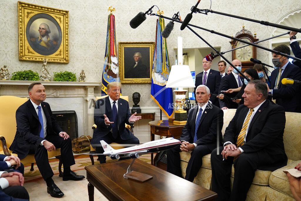 Evan Vucci President Donald Trump meets with Polish President Andrzej Duda in the Oval Office of the White House, Wednesday, June 24, 2020, in Washington, as Vice President Mike Pence and Secretary of State Mike Pompeo listen. (AP Photo/Evan Vucci)