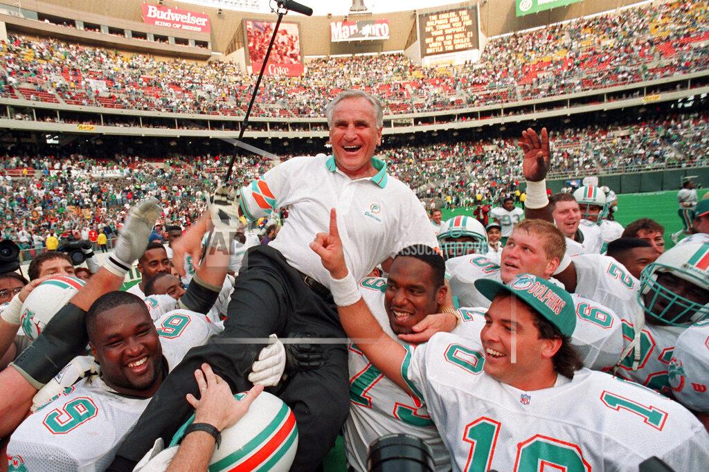 George Widman FILE - In this Nov. 14, 1993, file photo, Miami Dolphins coach Don Shula is carried on his team's shoulders after his 325th victory, against the Philadelphia Eagles in Philadelphia. Shula, who won the most games of any NFL coach and led the Miami Dolphins to the only perfect season in league history, died Monday, May 4, 2020, at his South Florida home, the team said. He was 90. (AP Photo/ George Widman)