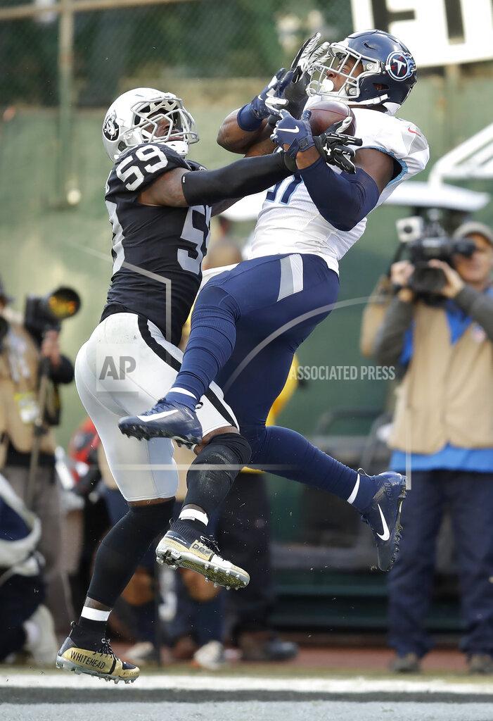 Ben Margot Tennessee Titans tight end Jonnu Smith, right, catches a touchdown pass against Oakland Raiders outside linebacker Tahir Whitehead (59) during the second half of an NFL football game in Oakland, Calif., Sunday, Dec. 8, 2019. (AP Photo/Ben Margot)