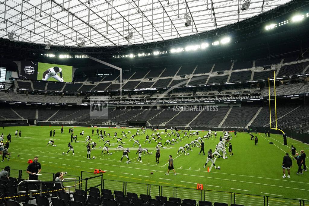 John Locher Las Vegas Raiders players stretch during an NFL football training camp practice at Allegiant Stadium, Friday, Aug. 21, 2020, in Las Vegas. (AP Photo/John Locher)