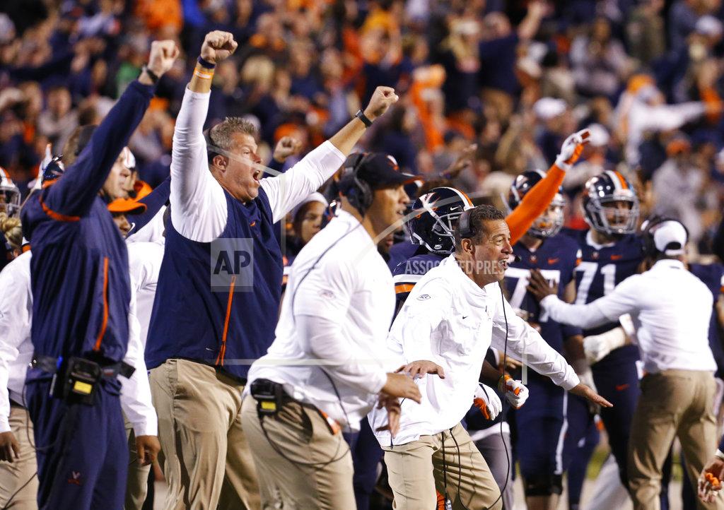 Steve Helber Members of the Virginia coaching staff celebrate a play during the second half of an NCAA college football game in Charlottesville, Va., Saturday, Oct. 13, 2018. Virginia defeated Miami 16-13. (AP Photo/Steve Helber)
