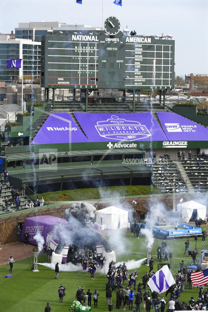 Paul Beaty Northwestern players run onto the field before a NCAA football game against Purdue on Saturday, Nov. 20, 2021, at Wrigley Field in Chicago. (AP Photo/Paul Beaty)