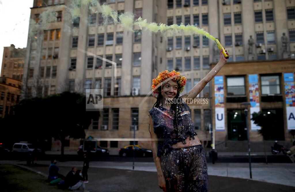 Natacha Pisarenko Eleven Alvarez poses for friends after graduating as a nutritionist, at a park amid the COVID-19 pandemic in Buenos Aires, Argentina, Wednesday, June 2, 2021. (AP Photo/Natacha Pisarenko)