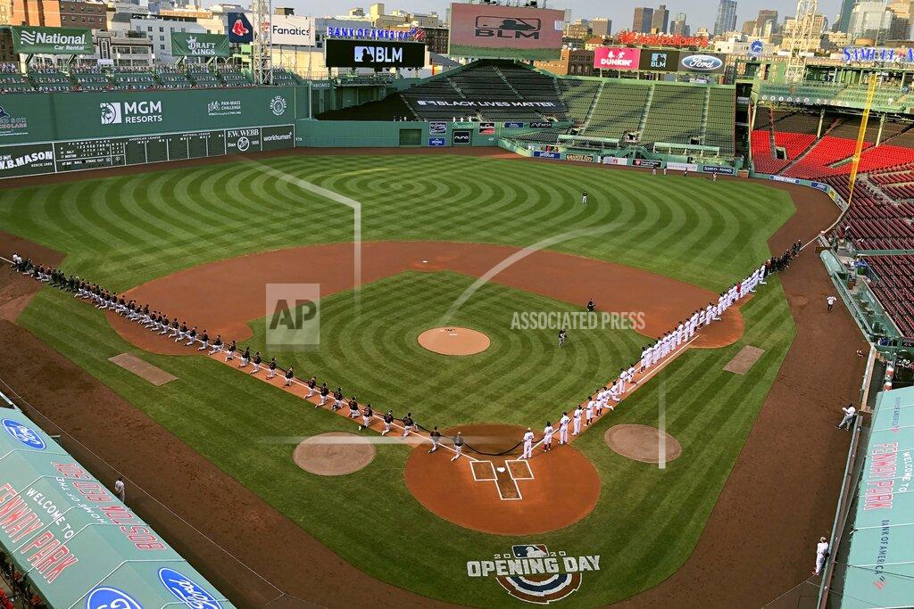 Kyle Hightower The Baltimore Orioles players and staff, left, and some of the Boston Red Sox players and staff, right, kneel along the baselines to acknowledge Black Lives Matter before the opening day baseball game, Friday, July 24, 2020, at Fenway Park in Boston. (AP Photo/Kyle Hightower)