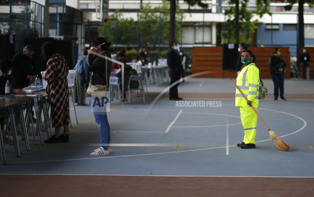 Luis Hidalgo People line up for their turn to vote at a polling station during a referendum to decide whether the country should replace its 40-year-old constitution, in Santiago, Chile, Sunday, Oct. 25, 2020. (AP Photo/Luis Hidalgo)