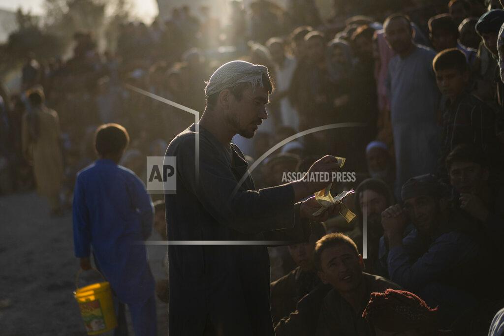 Bernat Armangue Afghans bet on a traditional wrestling match at the Chaman-e-Hozari Park in Kabul, Afghanistan, Friday, Sept. 17, 2021. (AP Photo/Bernat Armangue)