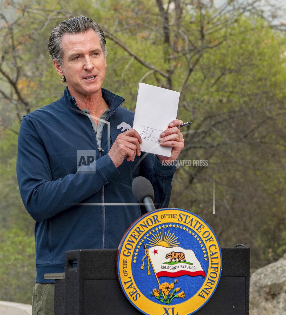 Ron Holman California Gov. Gavin Newsom shows media a climate package he signed into law on site Thursday, Sept. 23, 2021, in Sequoia National Park, Calif. Newsom on Thursday approved nearly $1 billion in new spending to prevent wildfires, signaling a policy shift in a state that historically focused more on putting out fires than stopping them before they start. (Ron Holman/The Times-Delta via AP)