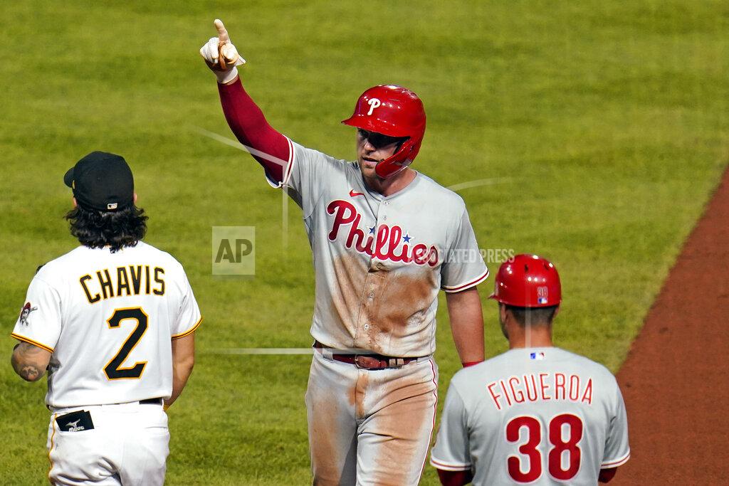 Gene J. Puskar Philadelphia Phillies' Rhys Hoskins, center, celebrates at first base after driving in a run with a single off Pittsburgh Pirates relief pitcher Wil Crowe during the seventh inning of a baseball game in Pittsburgh, Friday, July 29, 2022. (AP Photo/Gene J. Puskar)