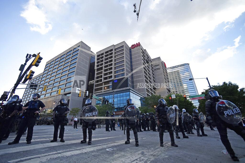 Mike Stewart Atlanta Police, monitor demonstrators protesting, Saturday, May 30, 2020 in Atlanta. The protest started peacefully earlier in the day before demonstrators clashed with police. (AP Photo/Mike Stewart)
