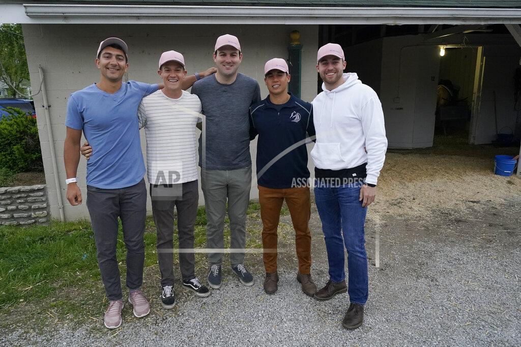 Charlie Riedel Former college teammates from left to right, Dan Giovacchini, Reiley Higgins, Alex Quoyeser, Patrick O'Neill and Eric Armagost, stand outside the barn housing Kentucky Derby entrant Hot Rod Charlie before a workout at Churchill Downs Wednesday, April 28, 2021, in Louisville, Ky. The group owns 25% of the horse being trained by O'Neill's uncle Doug O'Neill. (AP Photo/Charlie Riedel)