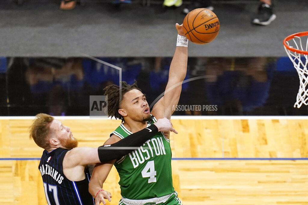 John Raoux Orlando Magic forward Ignas Brazdeikis, left, fouls Boston Celtics guard Carsen Edwards (4) as he goes up for a shot during the second half of an NBA basketball game, Wednesday, May 5, 2021, in Orlando, Fla. (AP Photo/John Raoux)